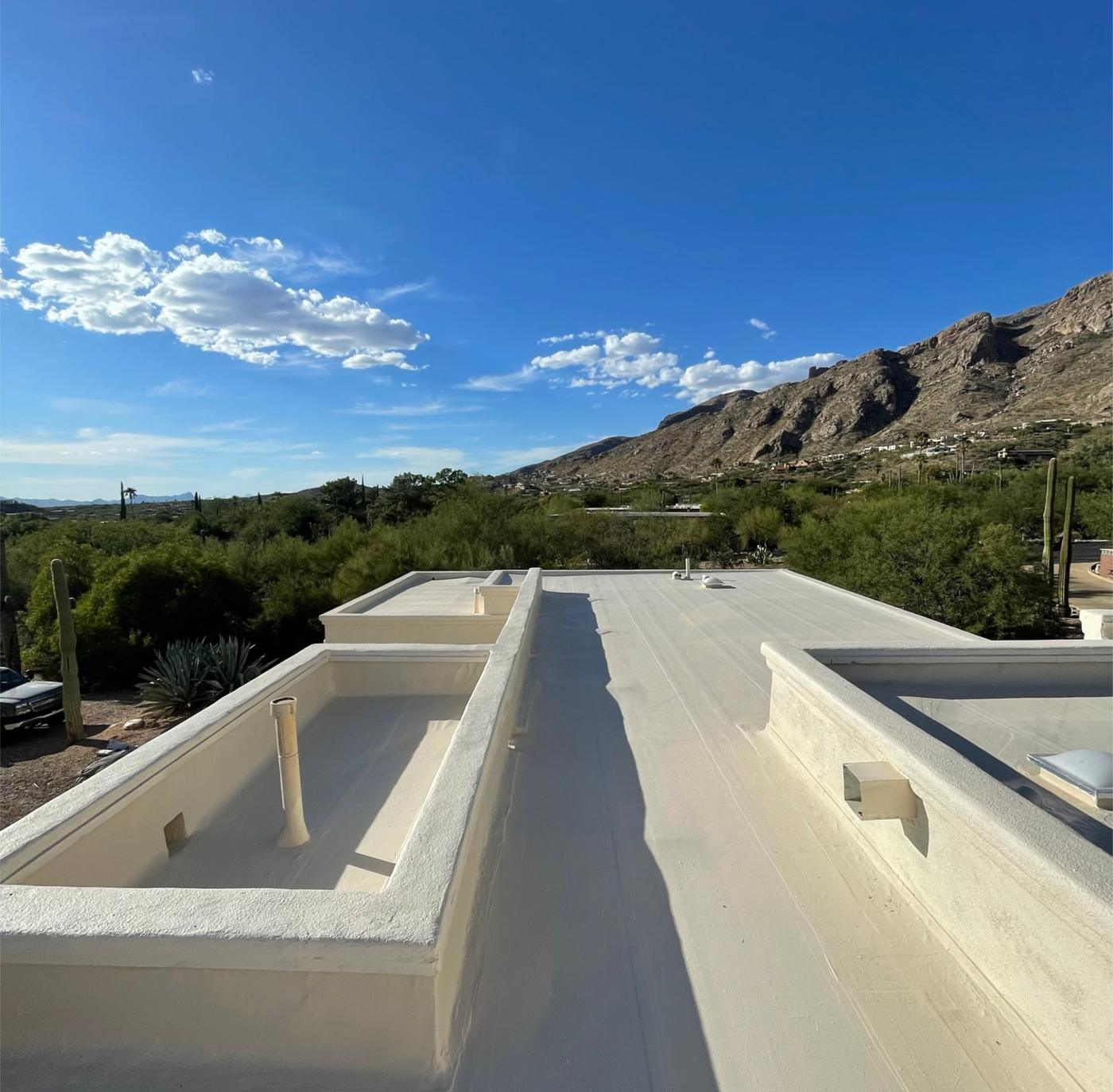 Finished Polyglass flat roof replacement with tan roof coating.