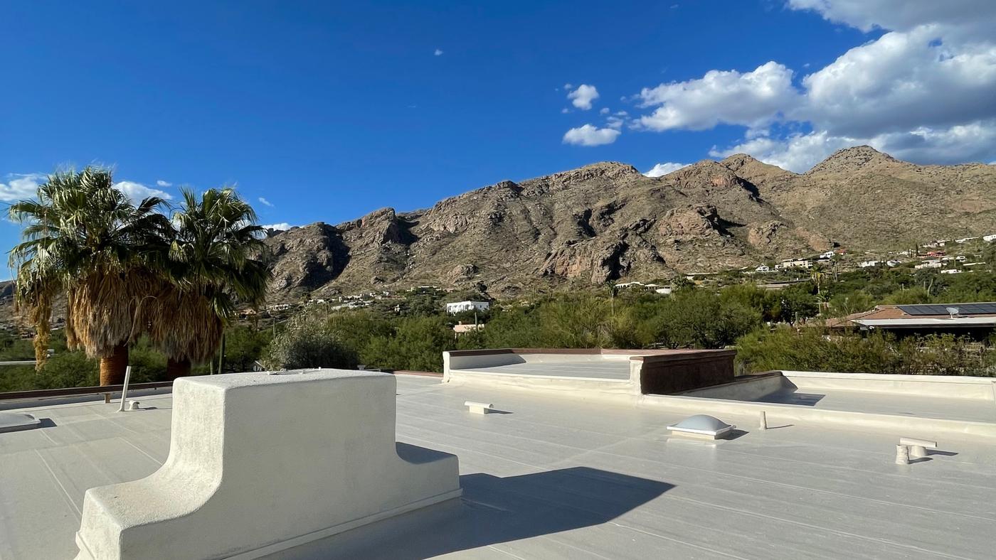 Finished Polyglass flat roof replacement with tan roof coating.
