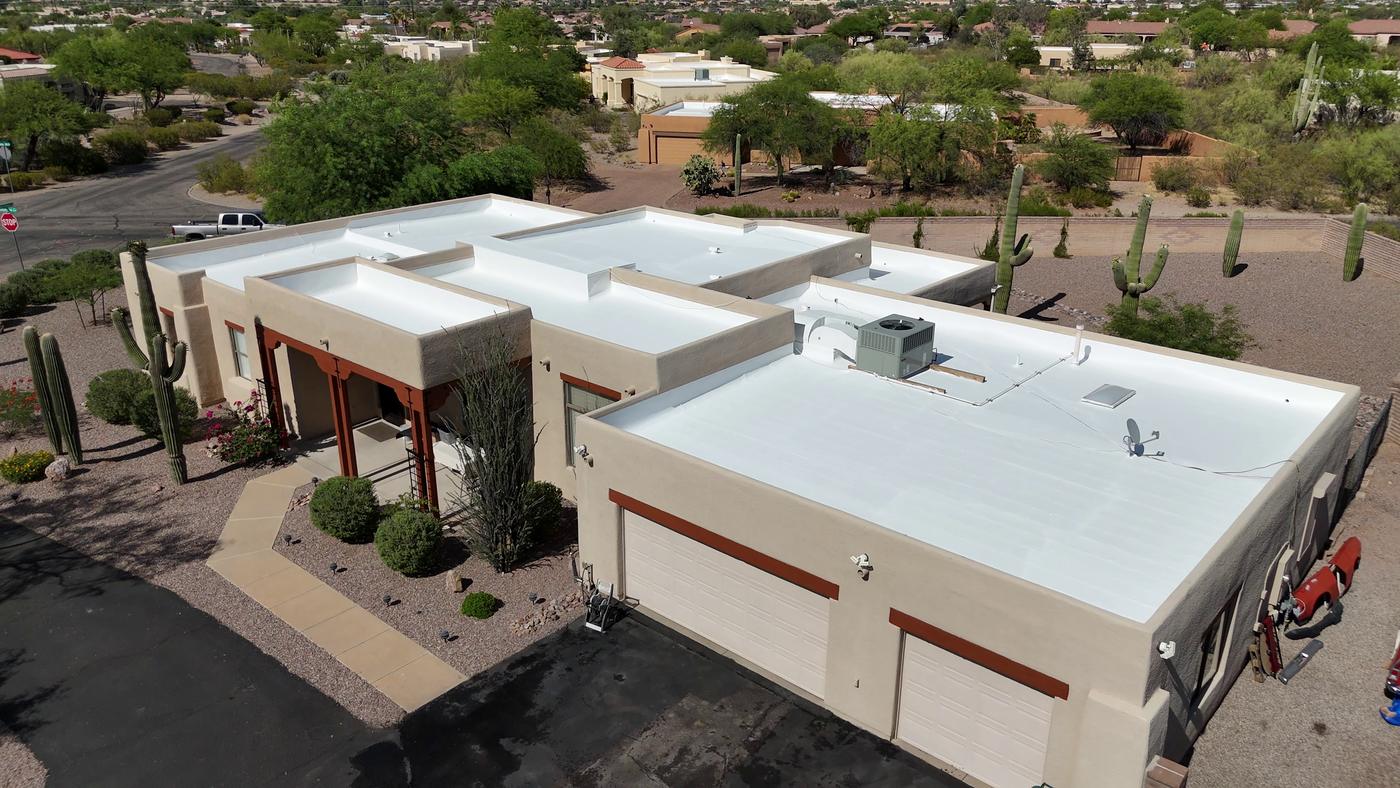 Aerial view of a freshly recoated flat roof.