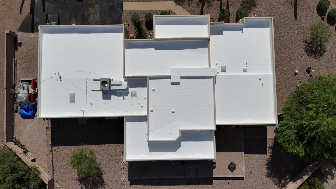 Aerial view of a freshly recoated flat roof.
