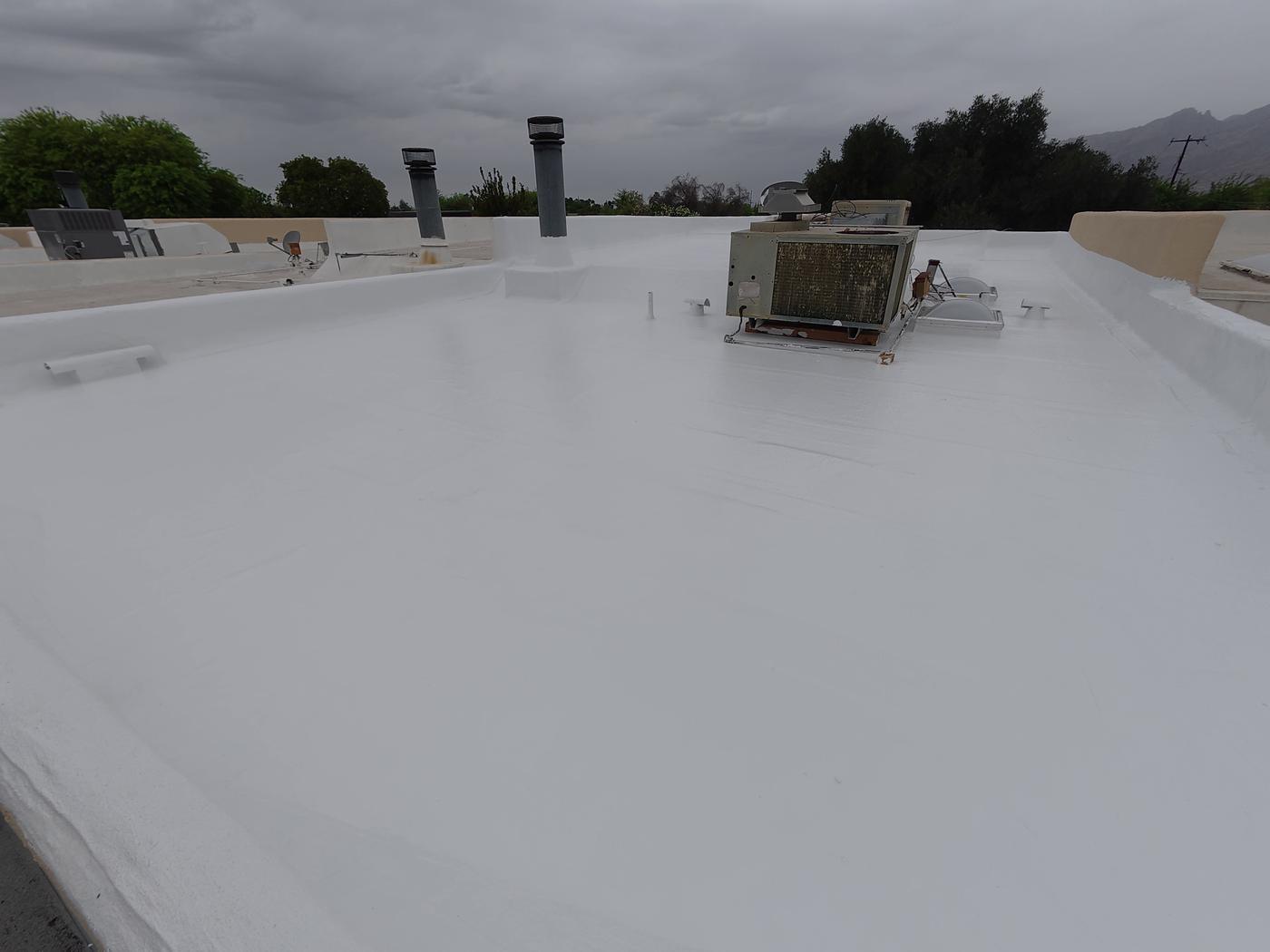 Flat roof coating application in progress — Flat & Coating, SolTerra Roofing
