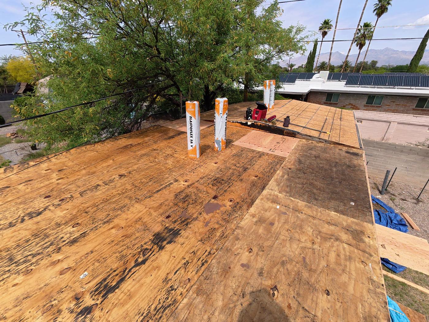 Clean, exposed roof decking during a flat roof replacement, before the new roofing is installed.