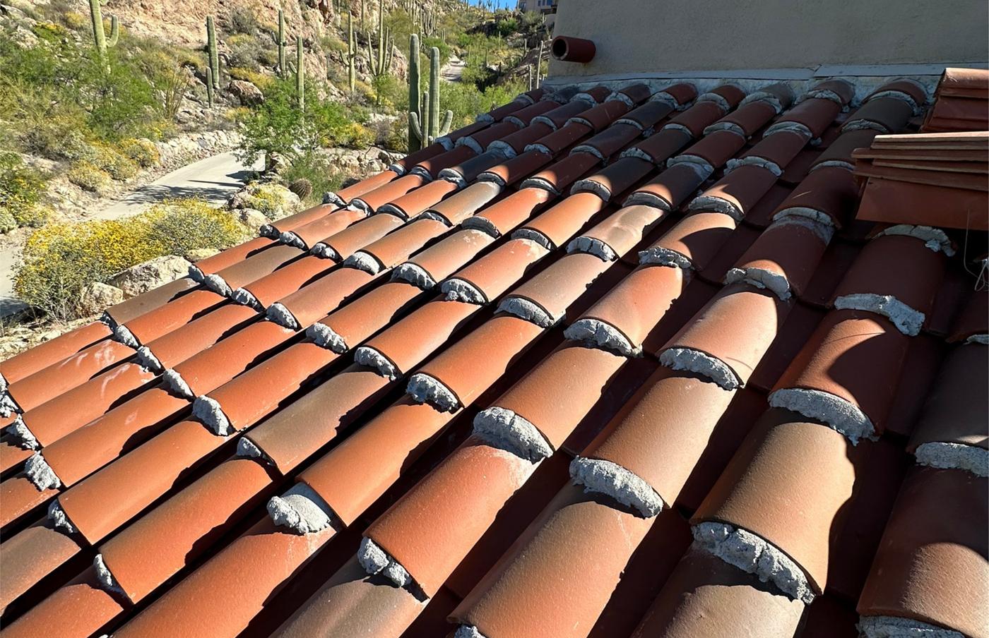 Clay tile roof repair in progress.