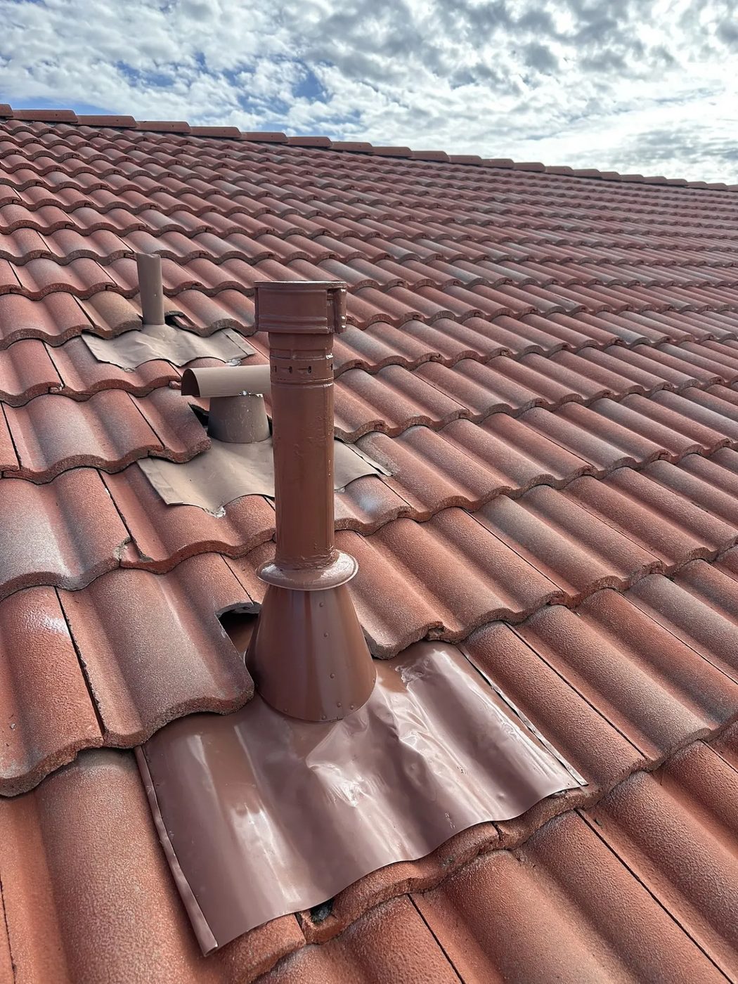 The same vent pipe after SolTerra installed new flashing and reset the tile