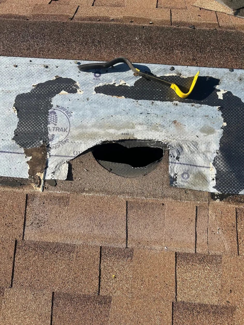 Opening cut through the roof decking with the underlayment turned back for a new vent