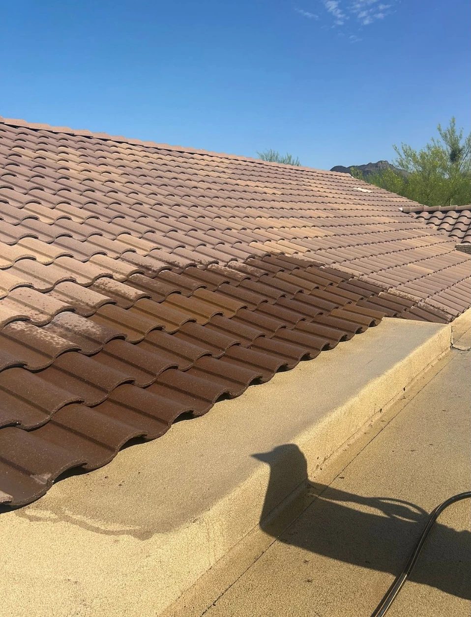 Finished tile meeting the coated flat roof, water tested along the transition