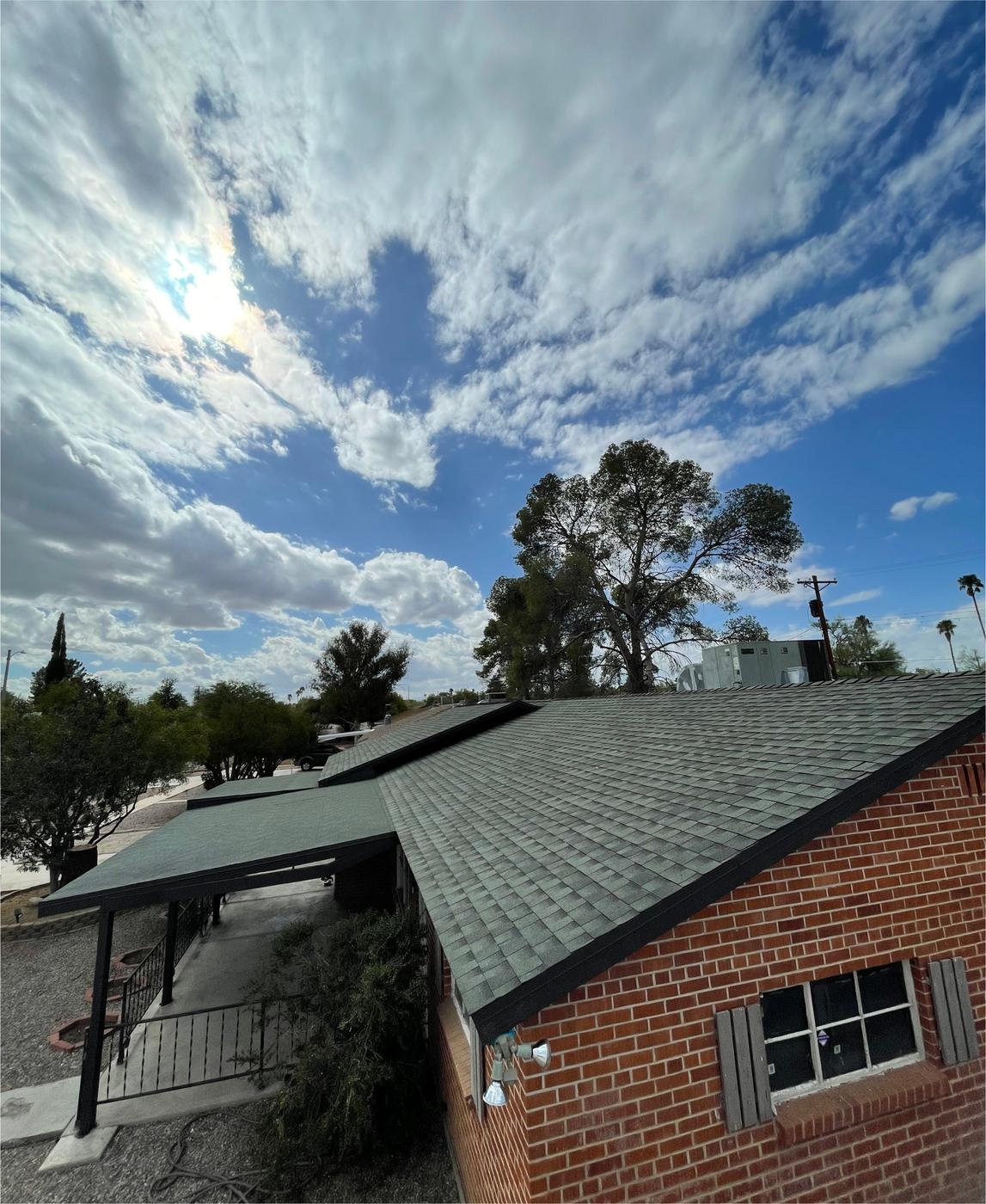 Finished GAF shingle roof adjoining a low-slope modified bitumen roof.