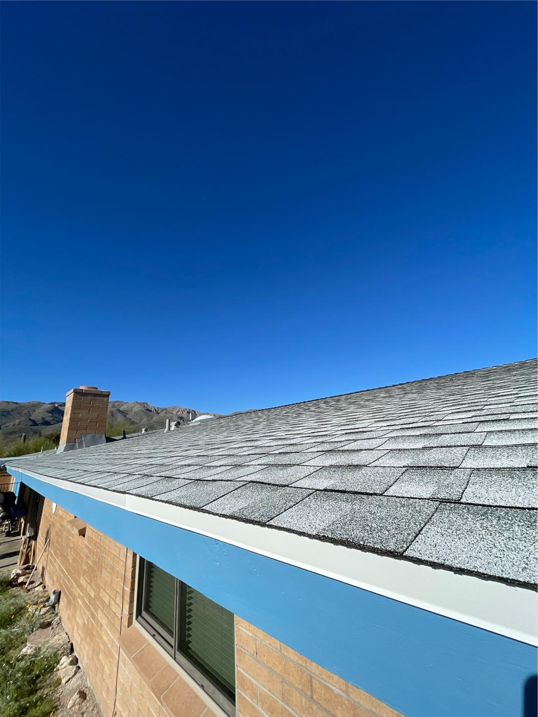 Pewter Gray shingle roof with blue fascia along the eave.