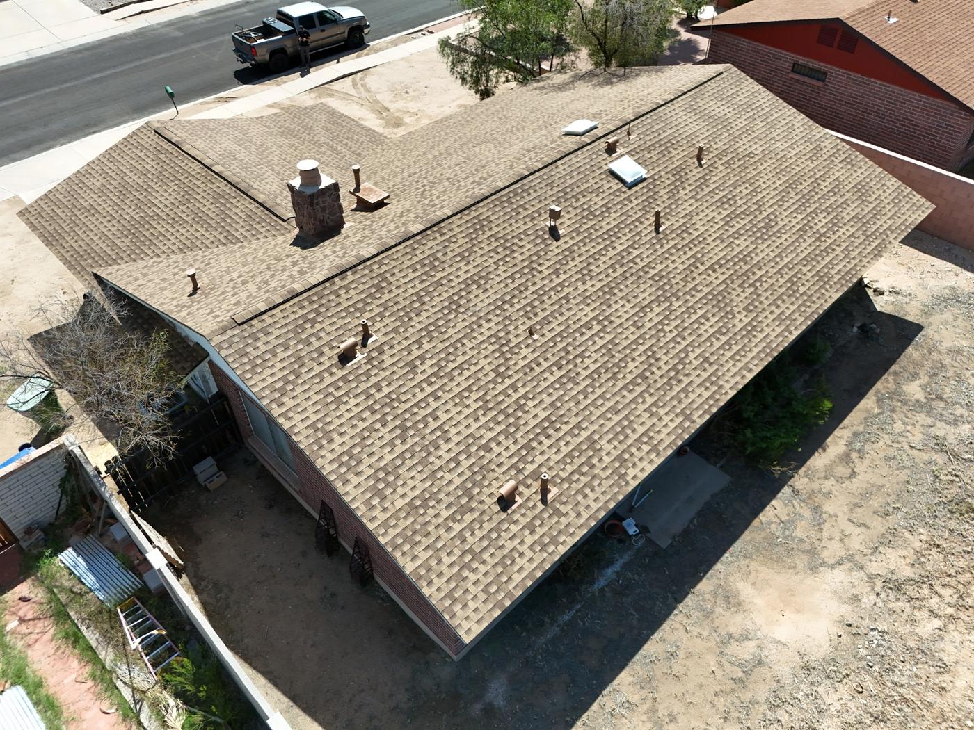 Aerial view of a finished asphalt shingle roof.
