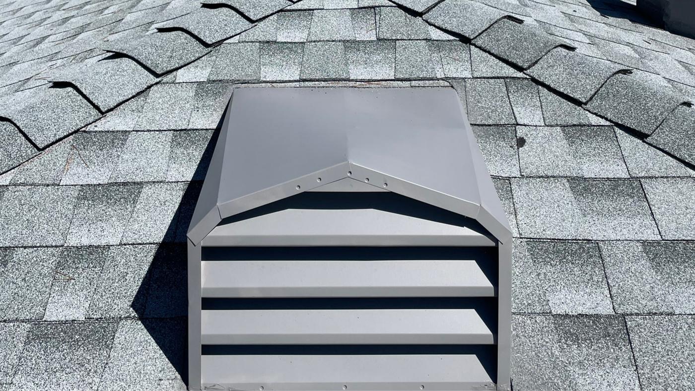 Roof vent and flashing detail on an asphalt shingle roof.
