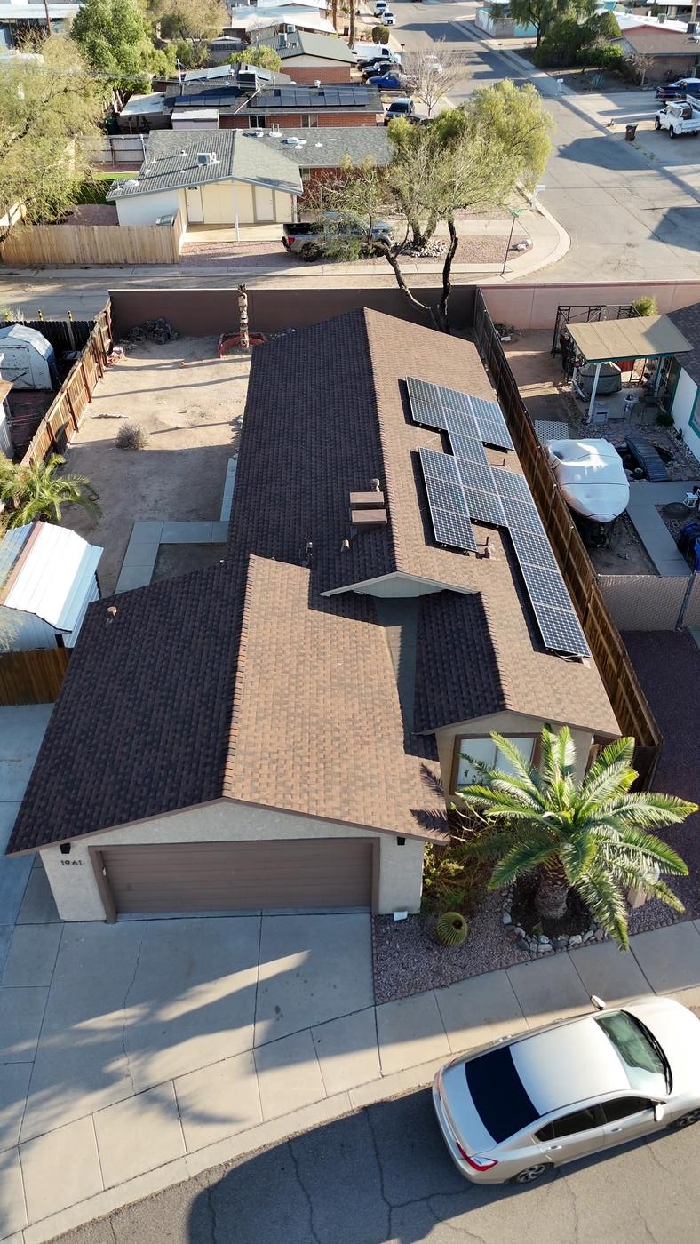Aerial view of a finished Barkwood shingle roof and reinstalled solar panels.