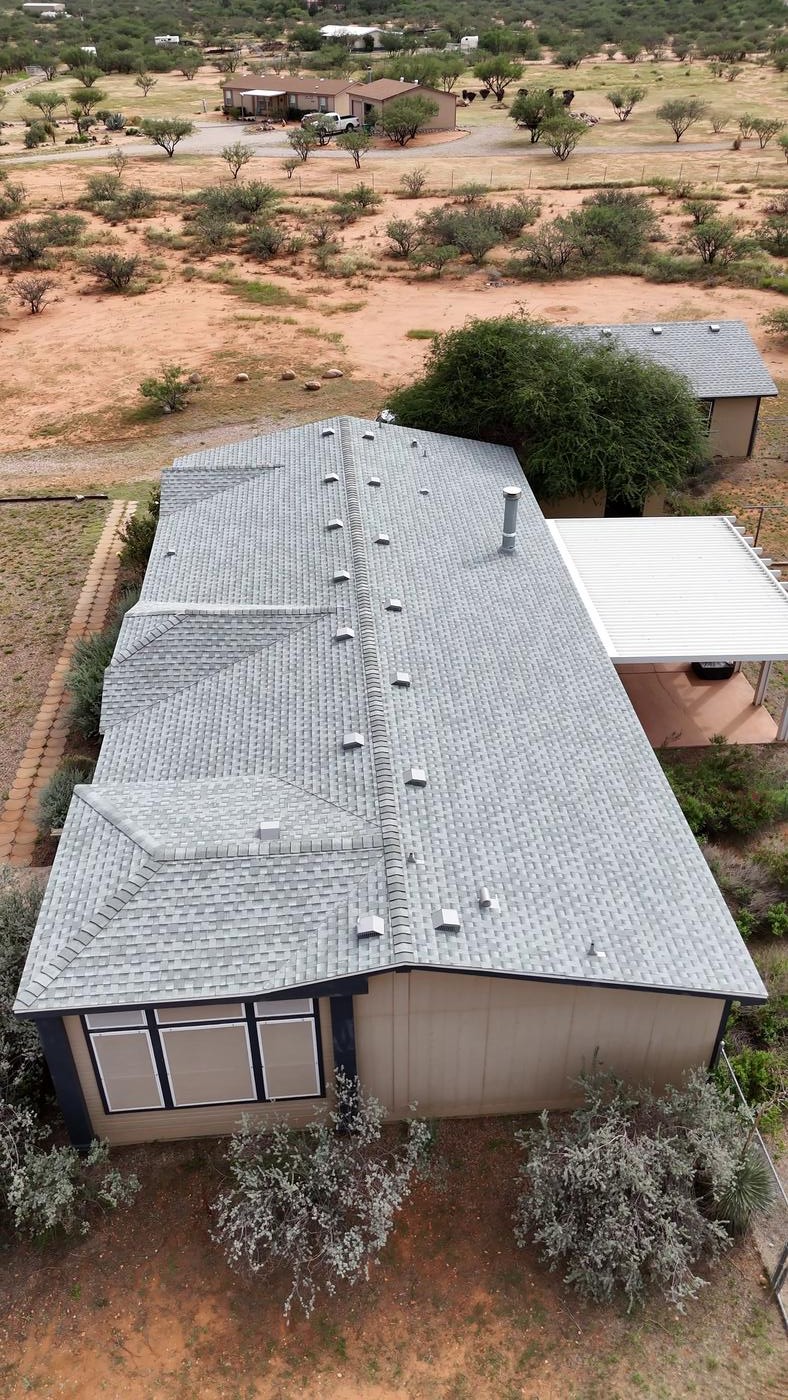 Overhead view of a finished asphalt shingle roof.
