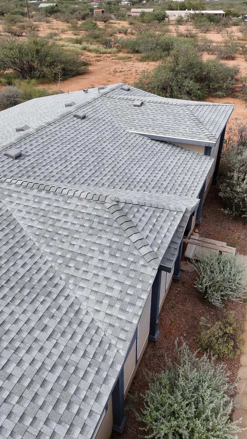 Angled aerial view of a finished asphalt shingle roof.