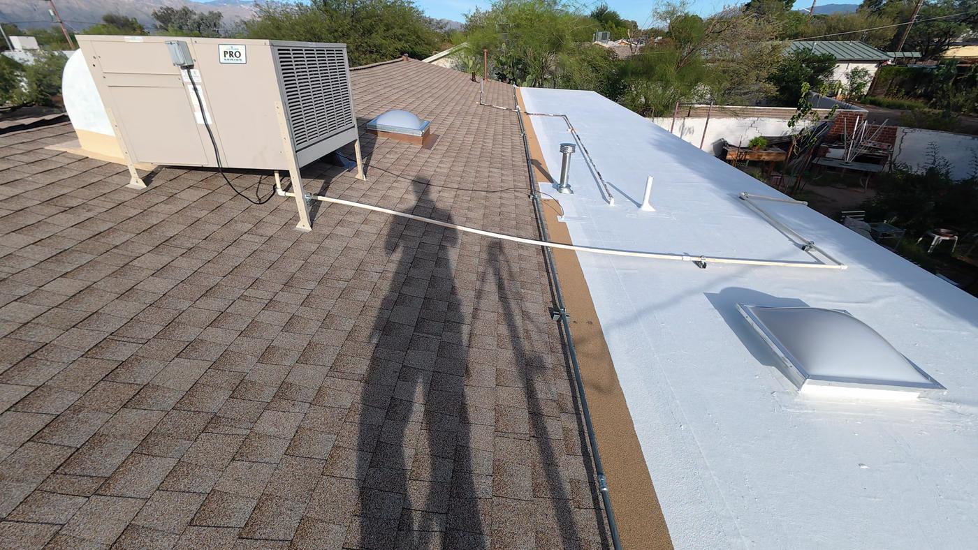 Finished shingle roof with a low-slope transition, evaporative cooler, and skylights.