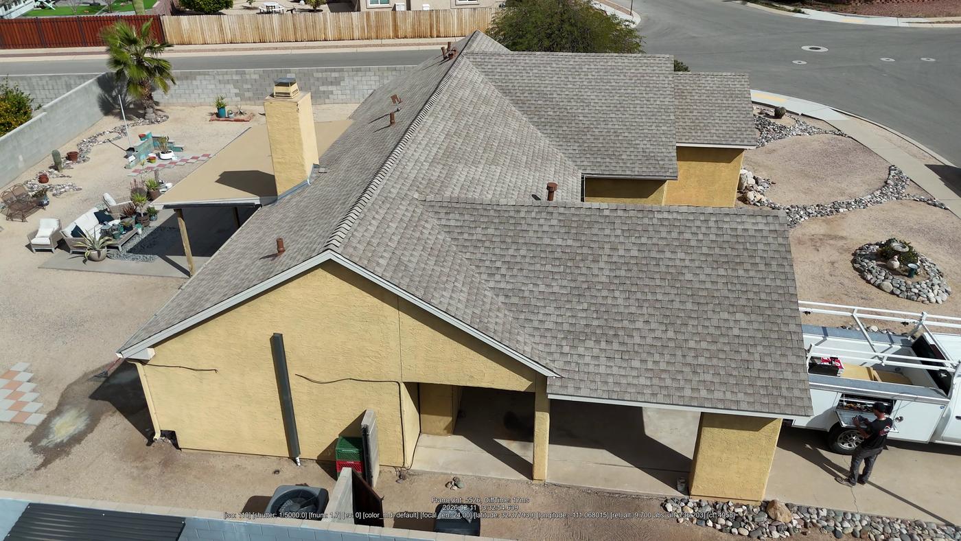Angled aerial view of a finished asphalt shingle roof.