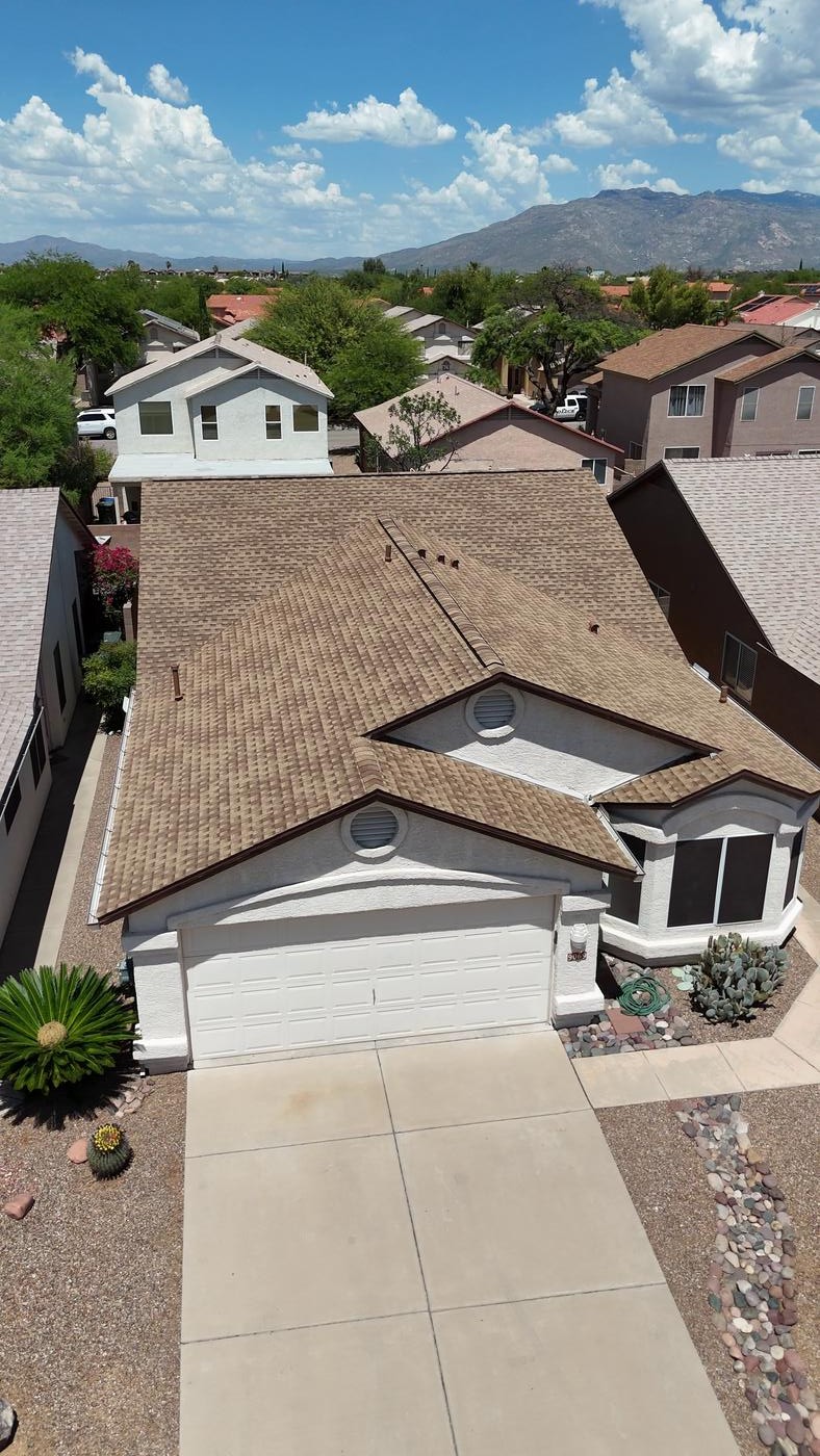 Aerial view of a finished asphalt shingle roof.