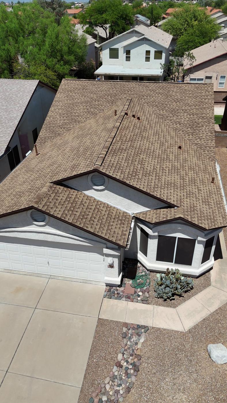 Angled aerial view of a finished asphalt shingle roof.