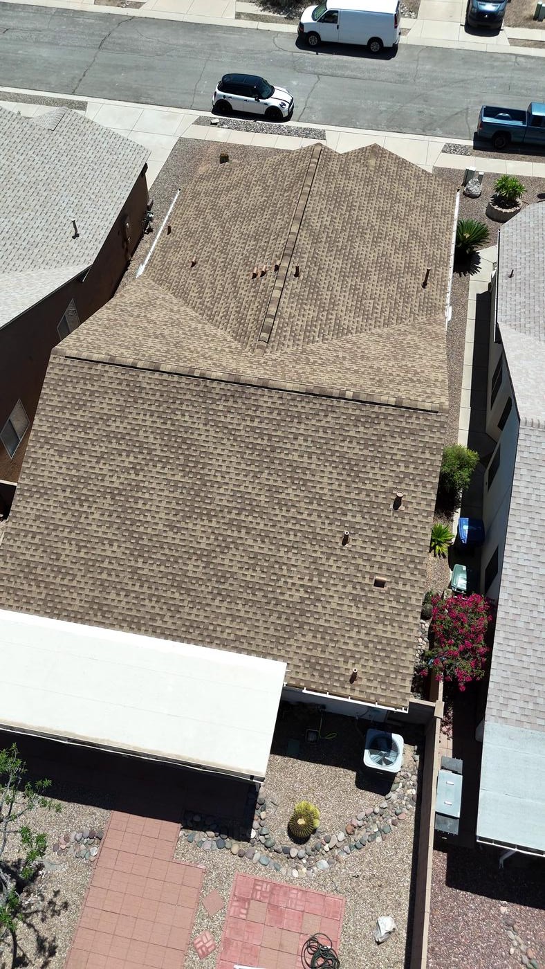 Overhead view of a finished asphalt shingle roof.