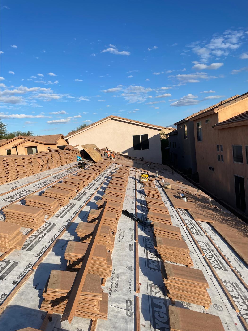 Flat-profile tile roof installation in progress.