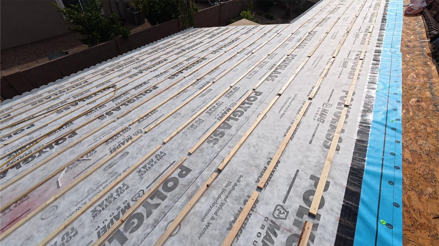 Two layers of roofing underlayment installed beneath a tile roof.