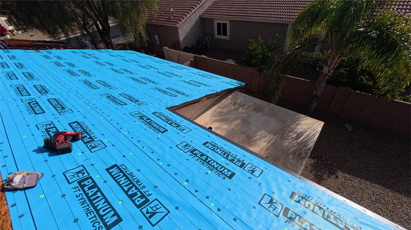 Synthetic roofing underlayment installed before concrete tiles are reset.