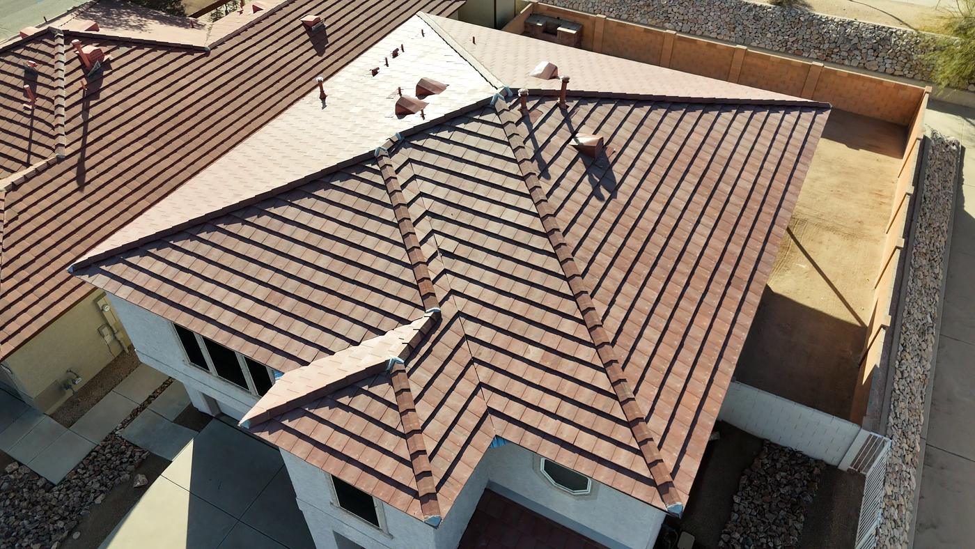 Aerial view of a finished flat-profile concrete tile roof on a two-story home.