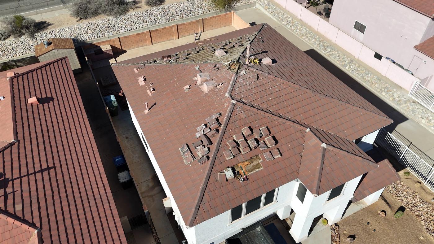 Existing flat-profile concrete tile roof before tile removal.