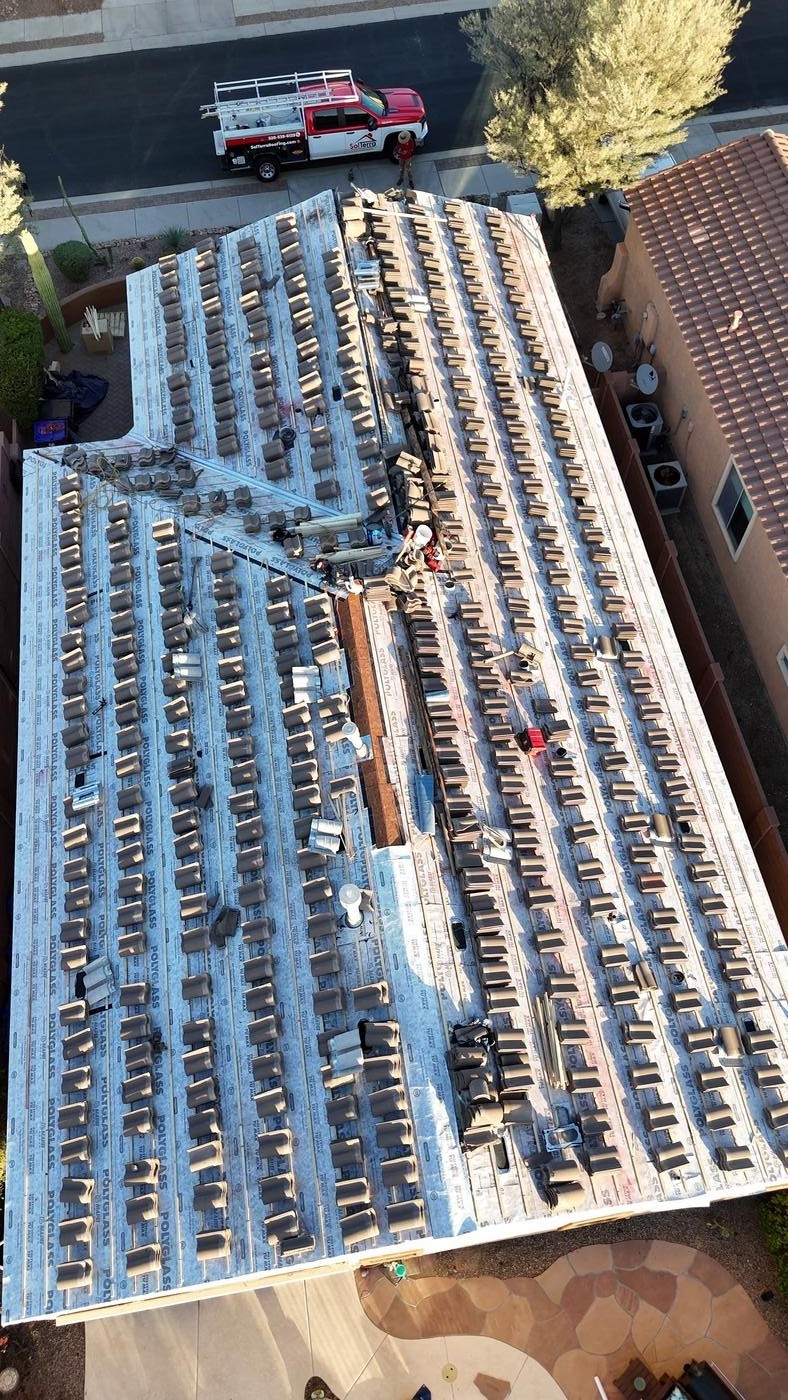 Concrete tile roof installation in progress.