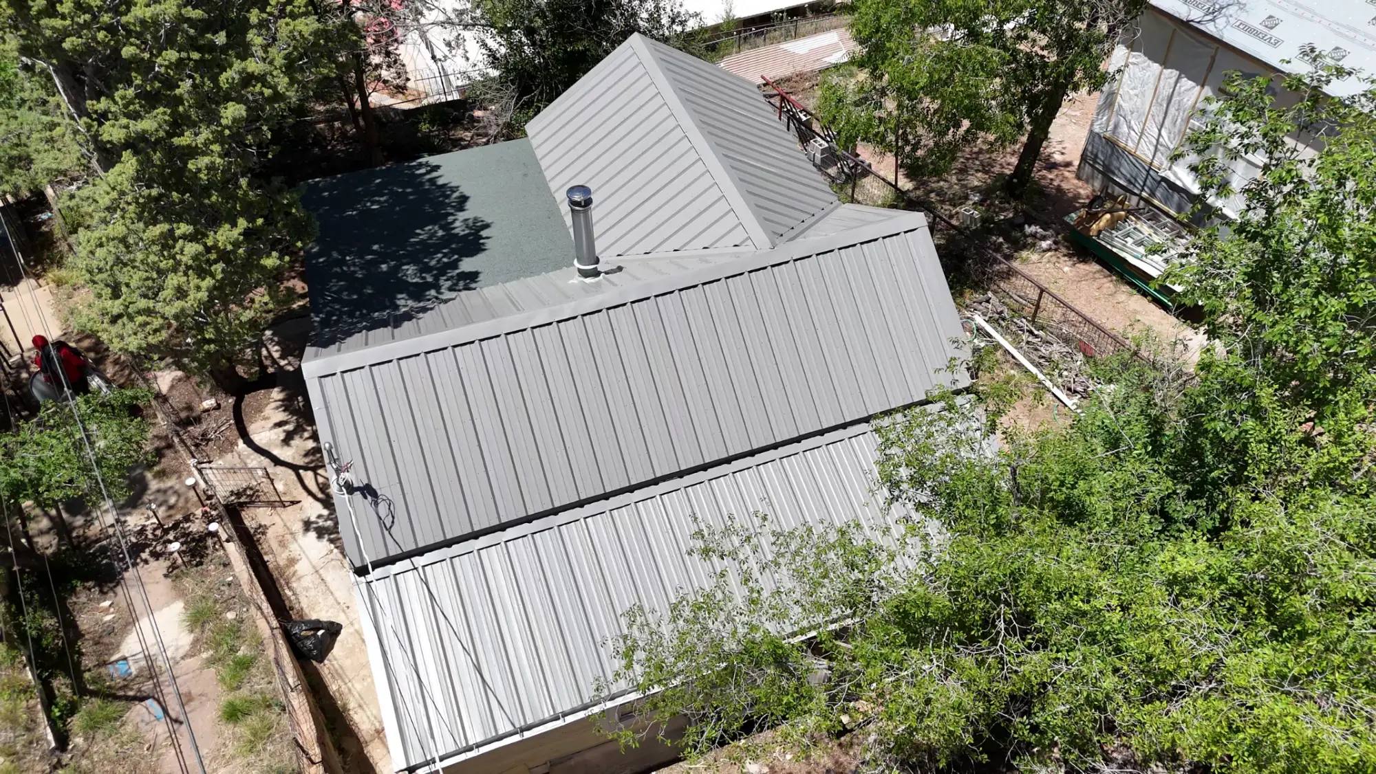 Aerial view of the same home after SolTerra Roofing replaced the worn shingles with a standing-seam metal roof