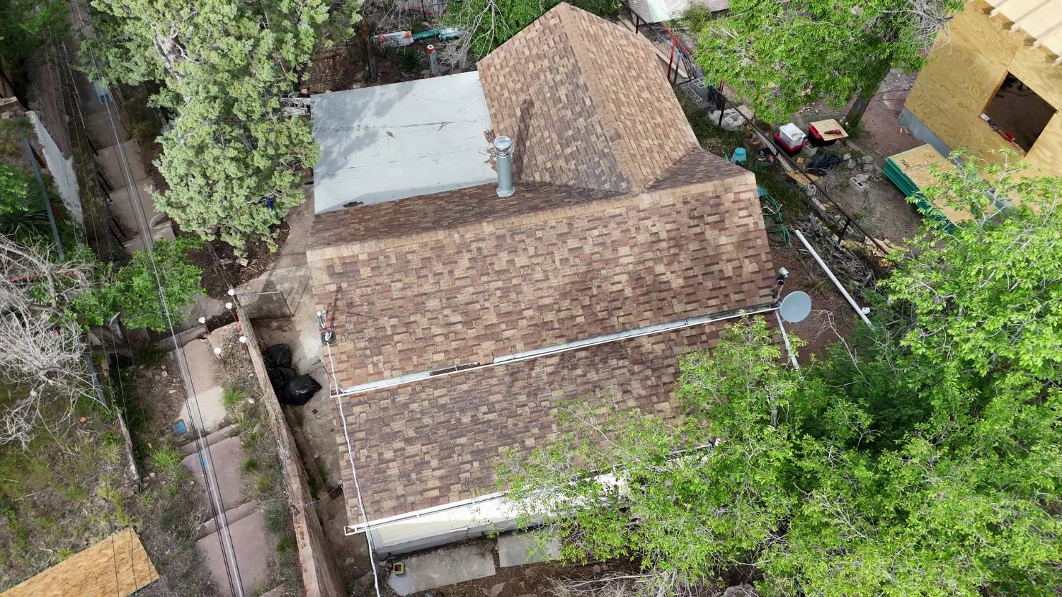 Aerial view of the same home before the job, with its worn and weathered shingle roof