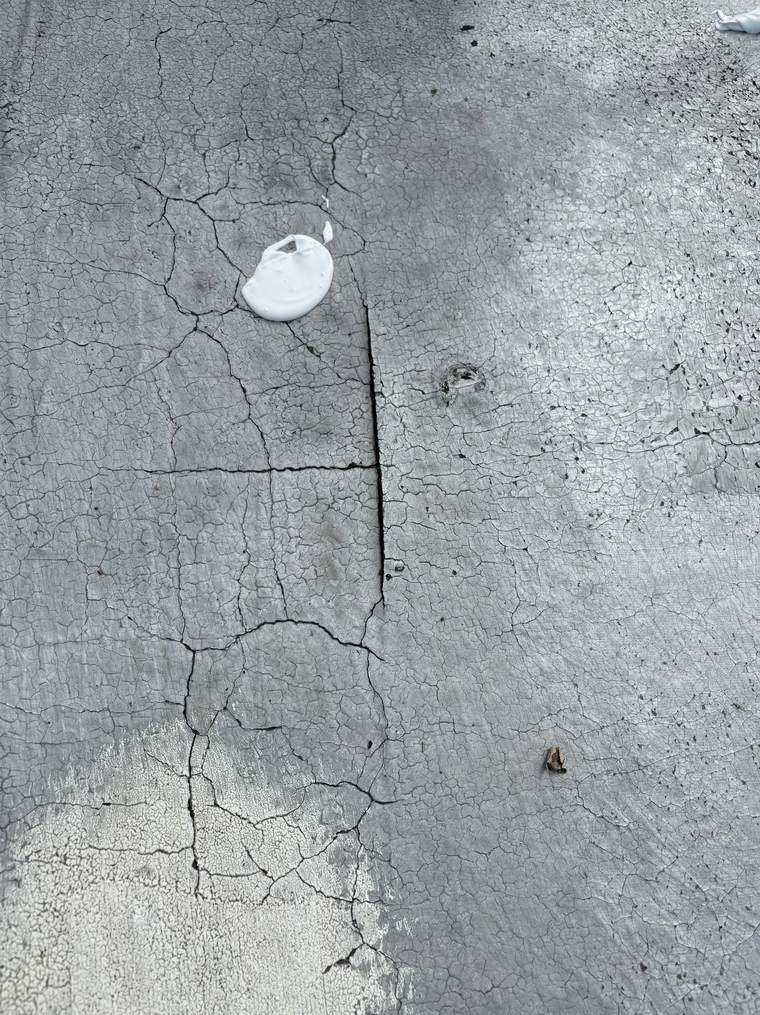 Existing expansion crack running across a Tucson flat roof before repair