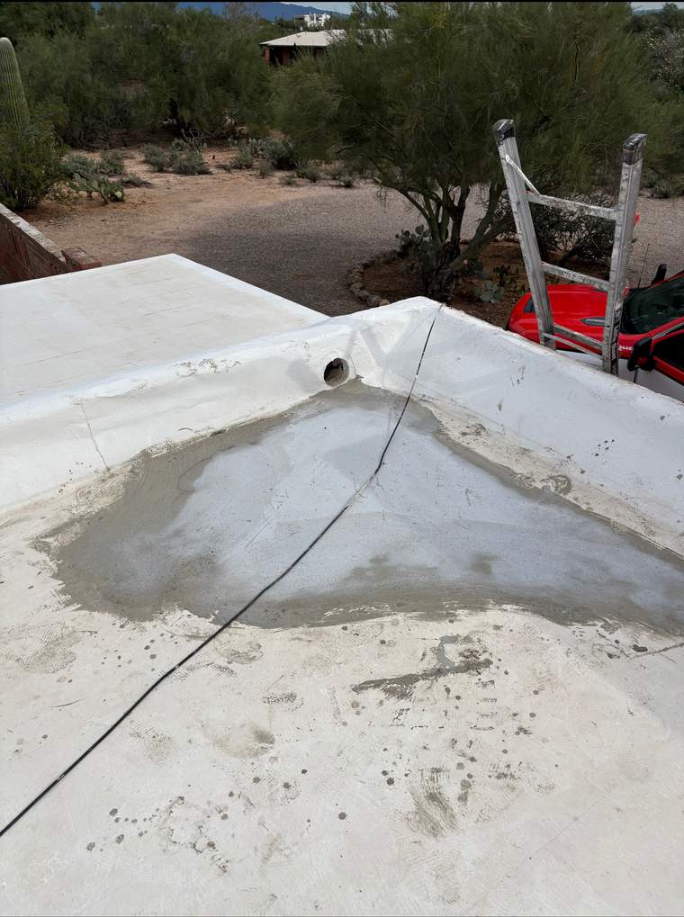 Slope-building compound applied to the low area to redirect water toward the roof drain
