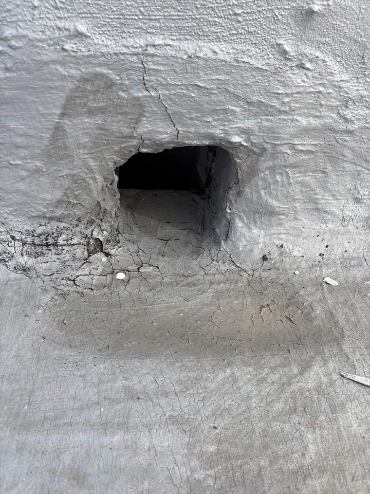 Cracked and failing scupper opening on a Tucson flat roof before repair