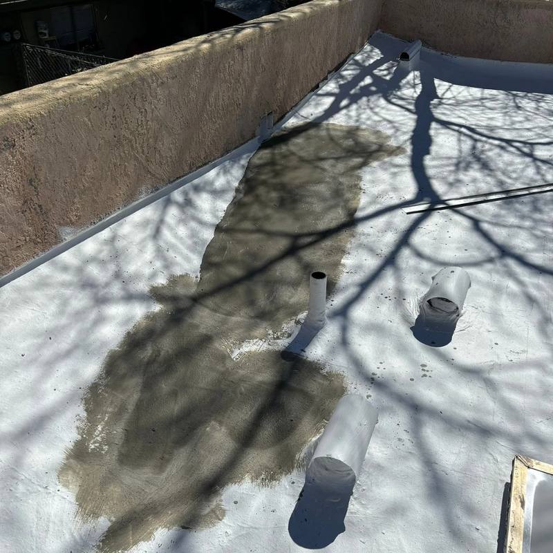 Slope-building compound worked into the low area of a flat roof