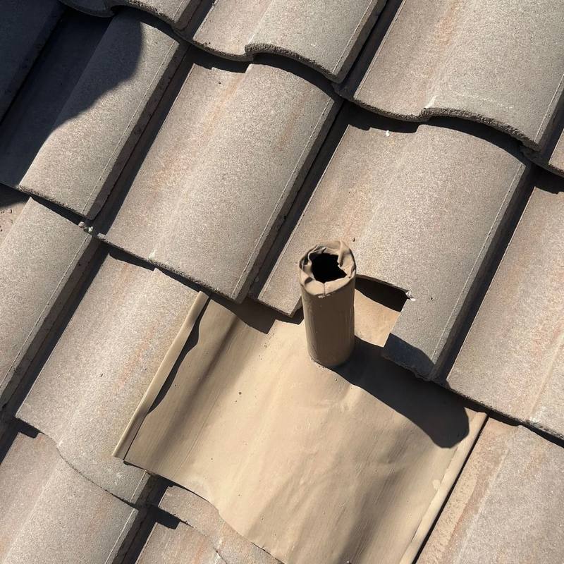 The same plumbing stack after SolTerra fitted a new flashing pan and reset the tile