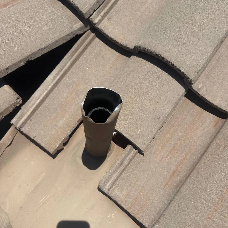 Plumbing stack on a Tucson tile roof with the tile cut away and its old flashing failing