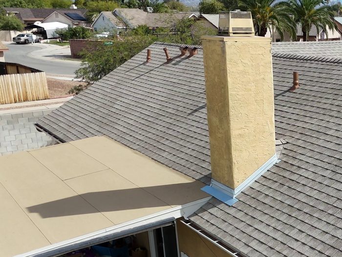 New roof flashing installed at a wall transition