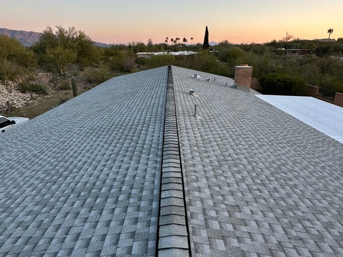 Ridge ventilation installed along a shingle roofline
